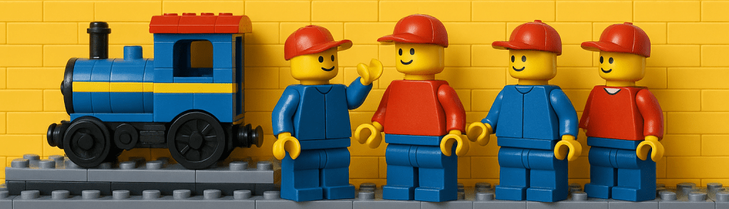 LEGO workers standing together beside a toy train, representing team training and empowerment supported by CyberStockroom’s Inventory Map and Inventory Visibility.